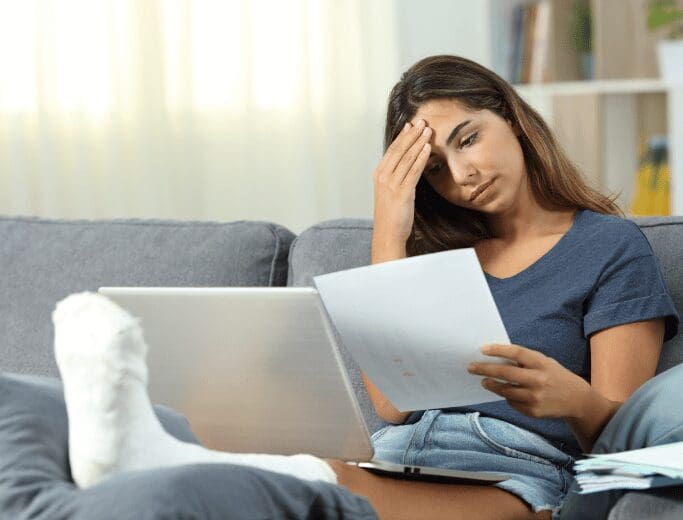 albuquerque-new-mexico-bad-faith-insurance-lawyer-1 A lady having a headache reading insurance paperwork