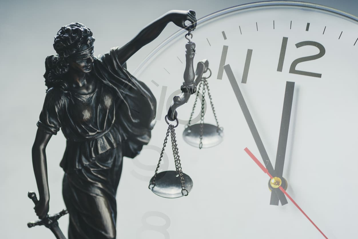 Justice holding the scales of justice and law