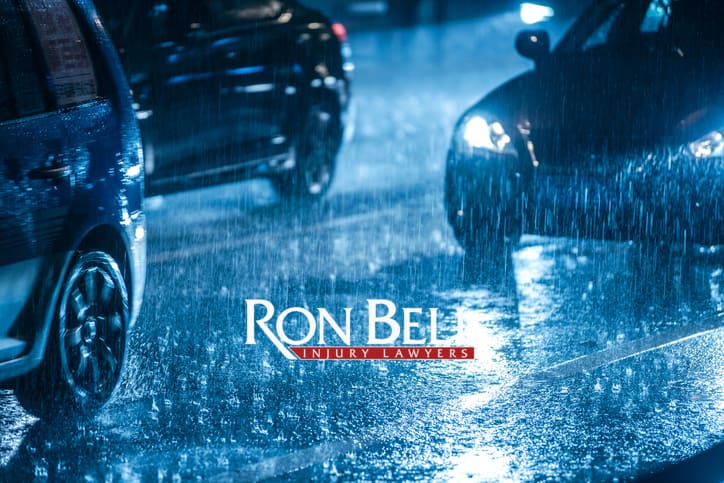 Cars driving on wet road in the rain with headlights