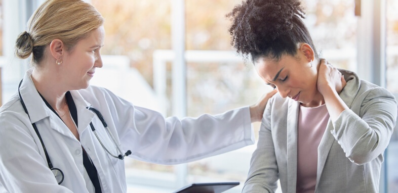 Personal-Injury doctor observing woman holding neck in discomfort