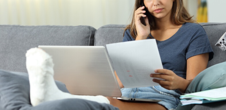 Social-Security-Disability-1 woman on the phone reviewing documentation